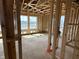 Living room framing with large windows, open layout, and visible studs showcasing the construction process and natural light at 618 Firefly Ct, Greenfield, IN 46140