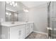 Bathroom featuring dual vanity sinks, gray tile flooring, and glass shower at 6723 Collisi Pl, Brownsburg, IN 46112