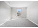 A spacious bedroom featuring neutral paint, plush carpeting, and bright natural light at 6723 Collisi Pl, Brownsburg, IN 46112