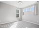 Bright bedroom featuring three windows, carpet flooring, and light gray walls at 6723 Collisi Pl, Brownsburg, IN 46112