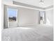 Bedroom featuring tray ceilings, light walls, and large windows for natural light at 6723 Collisi Pl, Brownsburg, IN 46112