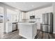 Kitchen features stainless steel appliances, white cabinets and a large island at 6723 Collisi Pl, Brownsburg, IN 46112