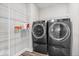 Laundry room featuring front loading washer and dryer set and wire rack shelving at 6723 Collisi Pl, Brownsburg, IN 46112