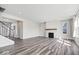 Open living room with hardwood floors, gas fireplace, and staircase at 6723 Collisi Pl, Brownsburg, IN 46112