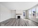 Living room with hardwood floors, gas fireplace, and many large windows at 6723 Collisi Pl, Brownsburg, IN 46112