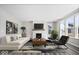 Bright living room features fireplace, large windows, and hardwood floors at 6723 Collisi Pl, Brownsburg, IN 46112