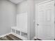 Hall tree with bench seating and storage beside a white interior door at 6723 Collisi Pl, Brownsburg, IN 46112