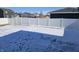 Spacious fenced backyard covered in snow on a sunny day in winter at 686 N Sobota Way, Trafalgar, IN 46181