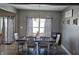 Inviting dining room with natural light, modern lighting fixture and dining table for eight at 686 N Sobota Way, Trafalgar, IN 46181