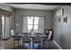 View of the dining room with natural light, decorative curtains, and dining table for eight at 686 N Sobota Way, Trafalgar, IN 46181