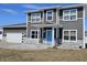 Two-story home featuring gray siding, white trim, a blue front door, and a two-car garage at 686 N Sobota Way, Trafalgar, IN 46181