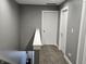 Upstairs hallway with carpeting and white doors to the bedrooms at 686 N Sobota Way, Trafalgar, IN 46181