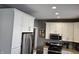 Well-lit kitchen featuring white cabinets, stainless steel appliances, and granite countertops at 686 N Sobota Way, Trafalgar, IN 46181