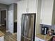 Spacious kitchen featuring white cabinets, stainless steel refrigerator, and granite countertops at 686 N Sobota Way, Trafalgar, IN 46181
