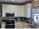 Bright kitchen with granite countertops, modern stainless steel microwave and stove at 686 N Sobota Way, Trafalgar, IN 46181