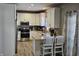 Modern kitchen with white cabinets, granite countertops, stainless steel appliances, and bar seating at 686 N Sobota Way, Trafalgar, IN 46181