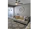 Comfortable living room features a neutral-toned sofa, decorative clock, and modern decor at 686 N Sobota Way, Trafalgar, IN 46181