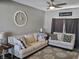 Cozy living room featuring neutral-toned sofas, a decorative clock, and modern decor at 686 N Sobota Way, Trafalgar, IN 46181