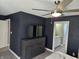 This bedroom features a ceiling fan, carpet floors, and an adjacent bathroom at 686 N Sobota Way, Trafalgar, IN 46181