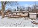 Wide backyard with a deck and covered patio. The yard features a firepit area and a shed at 6907 Buick Dr, Indianapolis, IN 46214