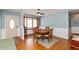 Charming dining area with a bay window, traditional table set, and a decorative front door entrance enhancing the cozy ambiance at 6907 Buick Dr, Indianapolis, IN 46214
