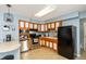 Functional kitchen featuring stainless steel appliances, wood cabinetry, and a breakfast bar, perfect for everyday cooking and dining at 6907 Buick Dr, Indianapolis, IN 46214