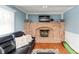 Cozy living room highlighting a brick fireplace, comfortable seating, and ample natural light, perfect for relaxation and entertainment at 6907 Buick Dr, Indianapolis, IN 46214