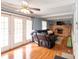 Cozy living room with French doors, a brick fireplace, and a comfortable black leather couch, perfect for relaxing evenings at 6907 Buick Dr, Indianapolis, IN 46214