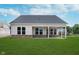 Spacious backyard view of the home with a covered patio and lush green lawn at 7026 Barrett Dr, Brownsburg, IN 46075