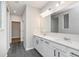 Modern bathroom with dual sinks, a large mirror, and white cabinetry at 7026 Barrett Dr, Brownsburg, IN 46075