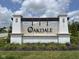 Oakdale Community entrance sign with brick pillars and manicured landscaping on a bright, sunny day at 7026 Barrett Dr, Brownsburg, IN 46075