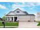 Charming two-story home featuring a two-car garage, well-manicured lawn, and welcoming front porch at 7026 Barrett Dr, Brownsburg, IN 46075