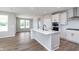 Bright, modern kitchen with a large island, stainless steel appliances, and pristine white cabinetry at 7026 Barrett Dr, Brownsburg, IN 46075