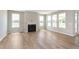 Spacious living room with a cozy fireplace and plenty of natural light from large windows at 7026 Barrett Dr, Brownsburg, IN 46075