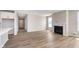 Open-concept living space with a fireplace and large windows allowing for ample sunlight at 7026 Barrett Dr, Brownsburg, IN 46075