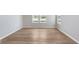 Bright living room featuring hardwood floors, two large windows, and neutral paint at 7026 Barrett Dr, Brownsburg, IN 46075