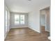 Bright living room featuring hardwood floors, two large windows, and neutral paint at 7026 Barrett Dr, Brownsburg, IN 46075