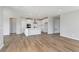 Expansive living space with a kitchen island, stainless appliances and wood-look flooring at 7026 Barrett Dr, Brownsburg, IN 46075