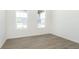 Bright bedroom with two windows, hardwood floors, and natural lighting at 7038 Barrett Dr, Brownsburg, IN 46112