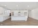 Bright, open kitchen featuring white cabinets, stainless steel appliances and a large central island at 7038 Barrett Dr, Brownsburg, IN 46112