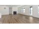 Bright living room area featuring a cozy fireplace and large windows bringing in ample natural light at 7038 Barrett Dr, Brownsburg, IN 46112