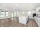 Open living space with kitchen island and views to fireplace, large windows and outdoor access at 7038 Barrett Dr, Brownsburg, IN 46112