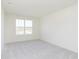 This spacious bedroom features neutral carpet, recessed lighting and a large window at 7197 Barrett Dr, Brownsburg, IN 46112