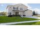 Charming two-story home boasts manicured lawn, neutral siding, and attached two car garage at 7197 Barrett Dr, Brownsburg, IN 46112
