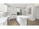 Bright kitchen featuring white cabinets, stainless steel appliances, island, and tile backsplash at 7197 Barrett Dr, Brownsburg, IN 46112