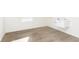 Laundry room features wood look flooring, white walls and utility sink at 7197 Barrett Dr, Brownsburg, IN 46112
