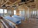 Interior framing of a room displaying insulation, wood studs, windows, and drywall stacked on the floor at 750 Oakleaf Dr, Greenfield, IN 46140