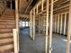 View of the home's unfinished interior displaying exposed wood framing, stairs, and the future location of the rooms at 750 Oakleaf Dr, Greenfield, IN 46140