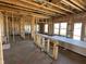 An unfinished home displaying framing, electrical wiring, windows, and stacked sheets of drywall on the floor at 750 Oakleaf Dr, Greenfield, IN 46140