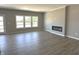 Spacious living room showcasing hardwood floors, a modern fireplace, and large windows at 750 Oakleaf Dr, Greenfield, IN 46140